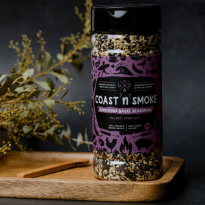 A jar of Bancoora Bagel seasoning on a wooden kitchen board