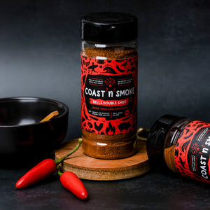 a jar of Espresso bbq rub with a bowl and bright red chilli to match the bright red label