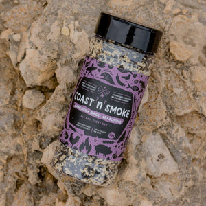 a shaker of everything but the bagel seasoning on a beach rock