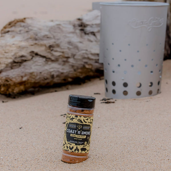 A jar of Winkipop dust seasoning on the beach stuck in the sand