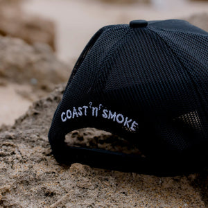 back view of black baseball cap with white branding