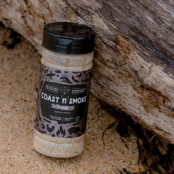 a container of T-rub on the beach with drift wood