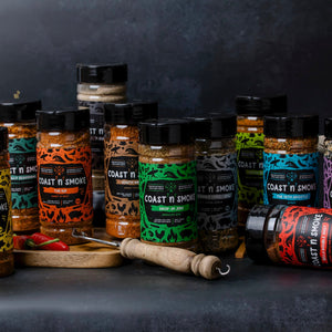 Collection of bbq rubs and seasonings with kitchen tools and spices