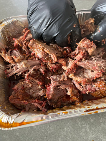 Beef being pulled in an aluminium foil tray