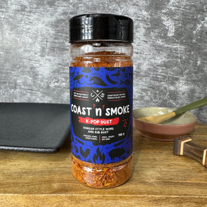 dark blue labelled bbq rub on a wooden board with dishes around it