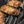 Chicken wing nibbles coated in spices on a BBQ grill